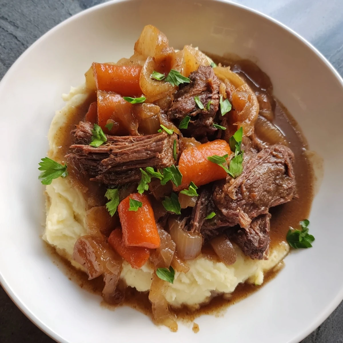 Tender slow cooker pot roast with carrots and potatoes, a hearty family meal.