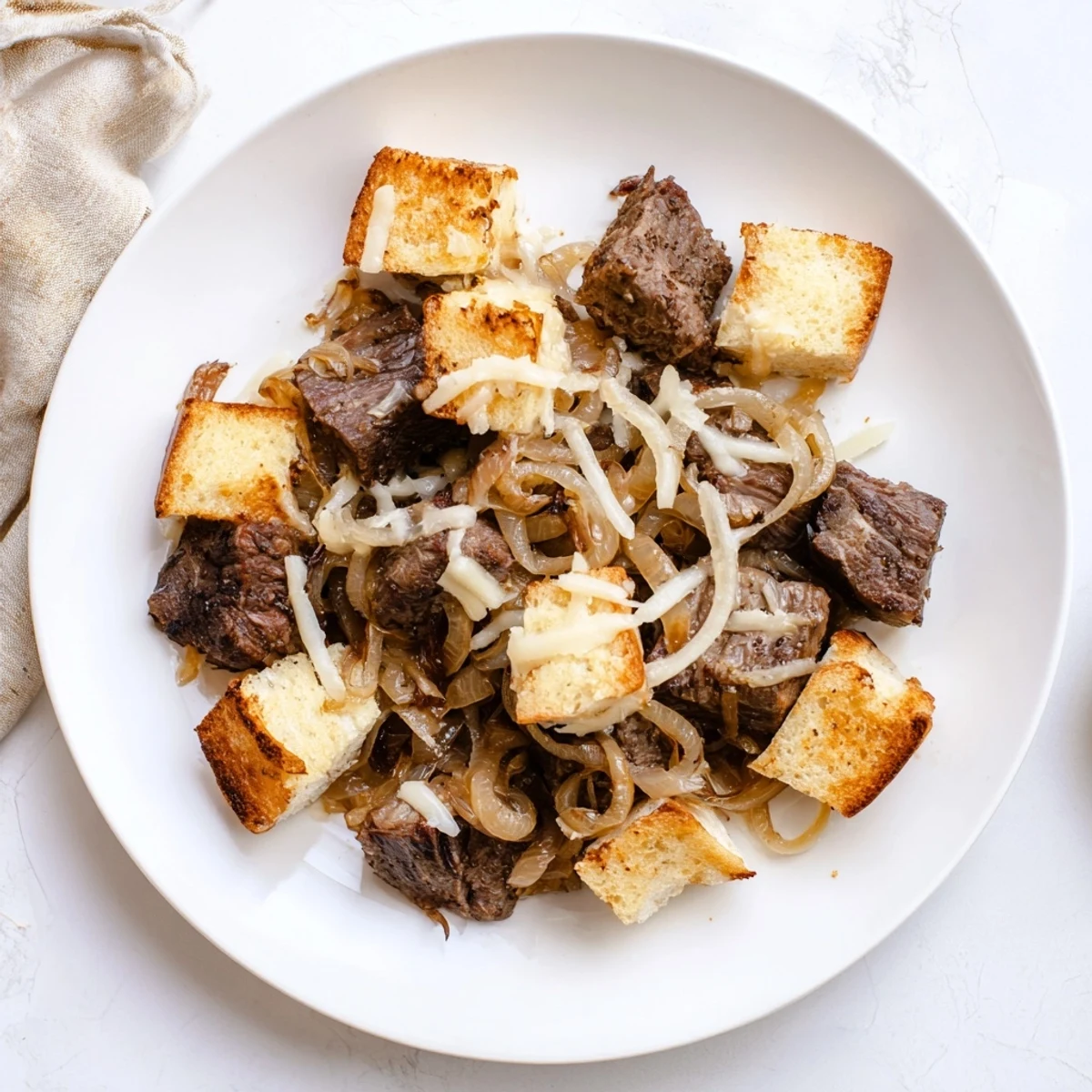 Melty cheese crowns this French Onion Pot Roast Casserole alongside toasty bread, perfect for a chilly evening.