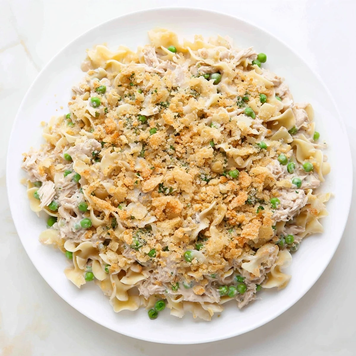 Golden-brown Creamy Tuna Noodle Casserole with a crispy Ritz cracker topping, ready to serve.