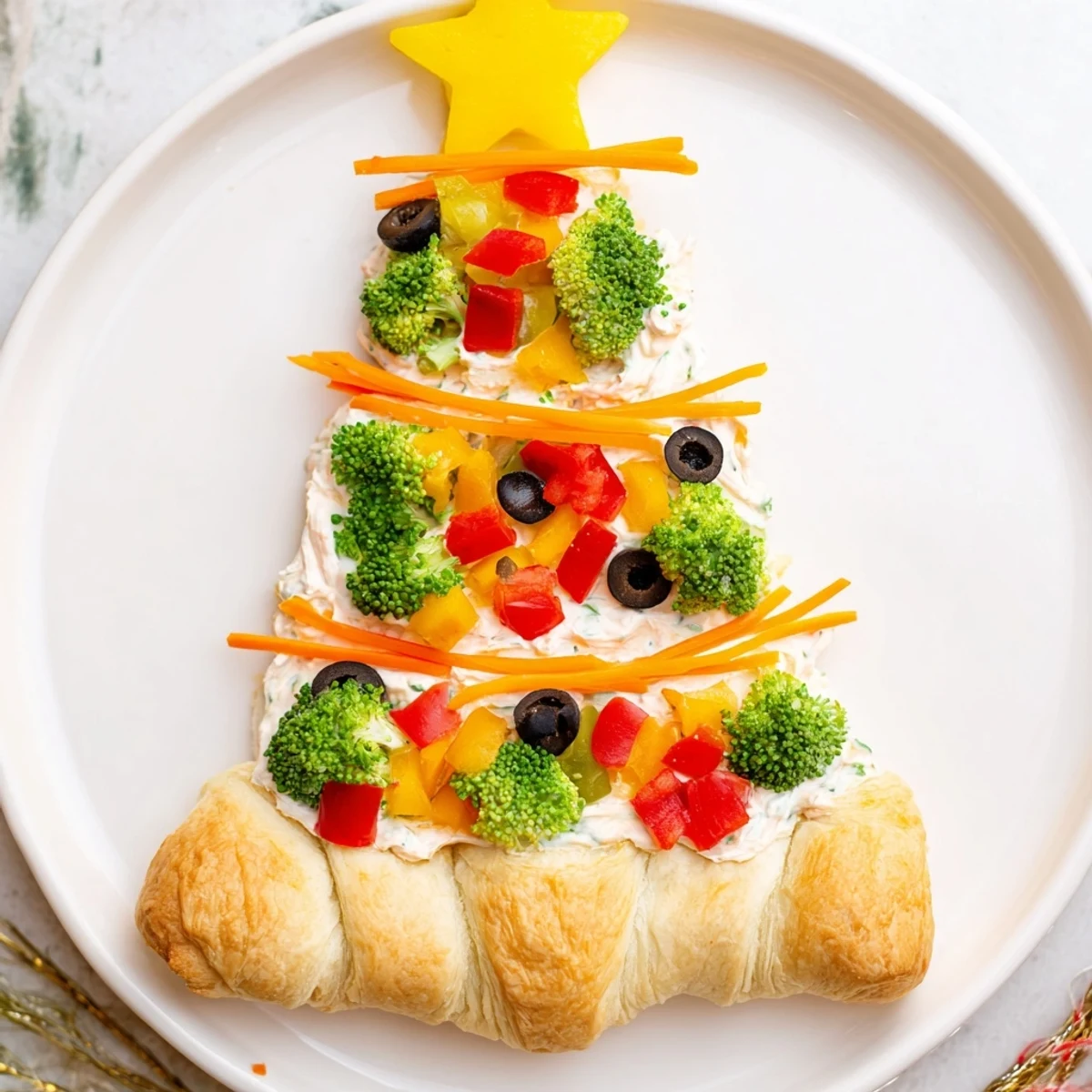 Freshly made Easy Christmas Tree Veggie Pizza with colorful bell peppers, ideal appetizer for the holidays.