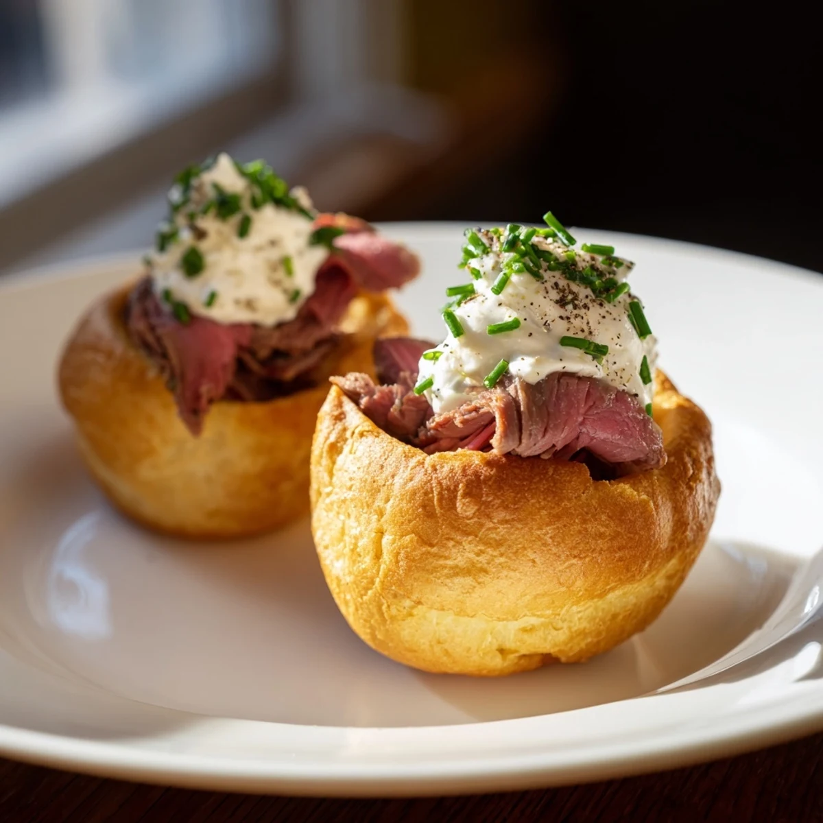Crisp, puffed Express Holiday Yorkshire Pudding Bites, a savory appetizer brimming with roast beef filling.