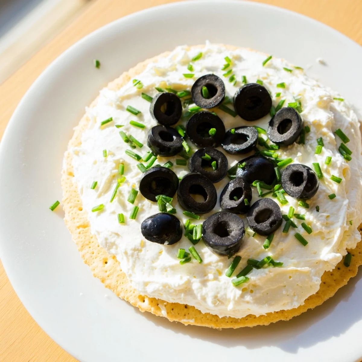 Vibrant Olympic ring appetizers with cream cheese, olives, peppers & more, perfect for a celebration.