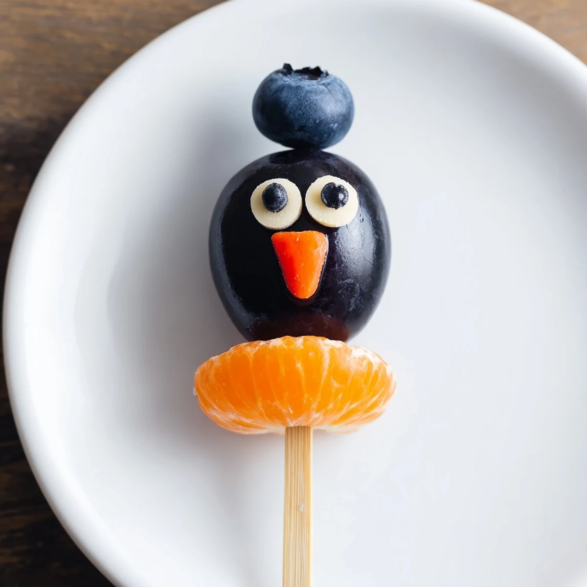 Freshly assembled Penguin Fruit Skewer Army, a playful and vibrant healthy treat made with various fruits.