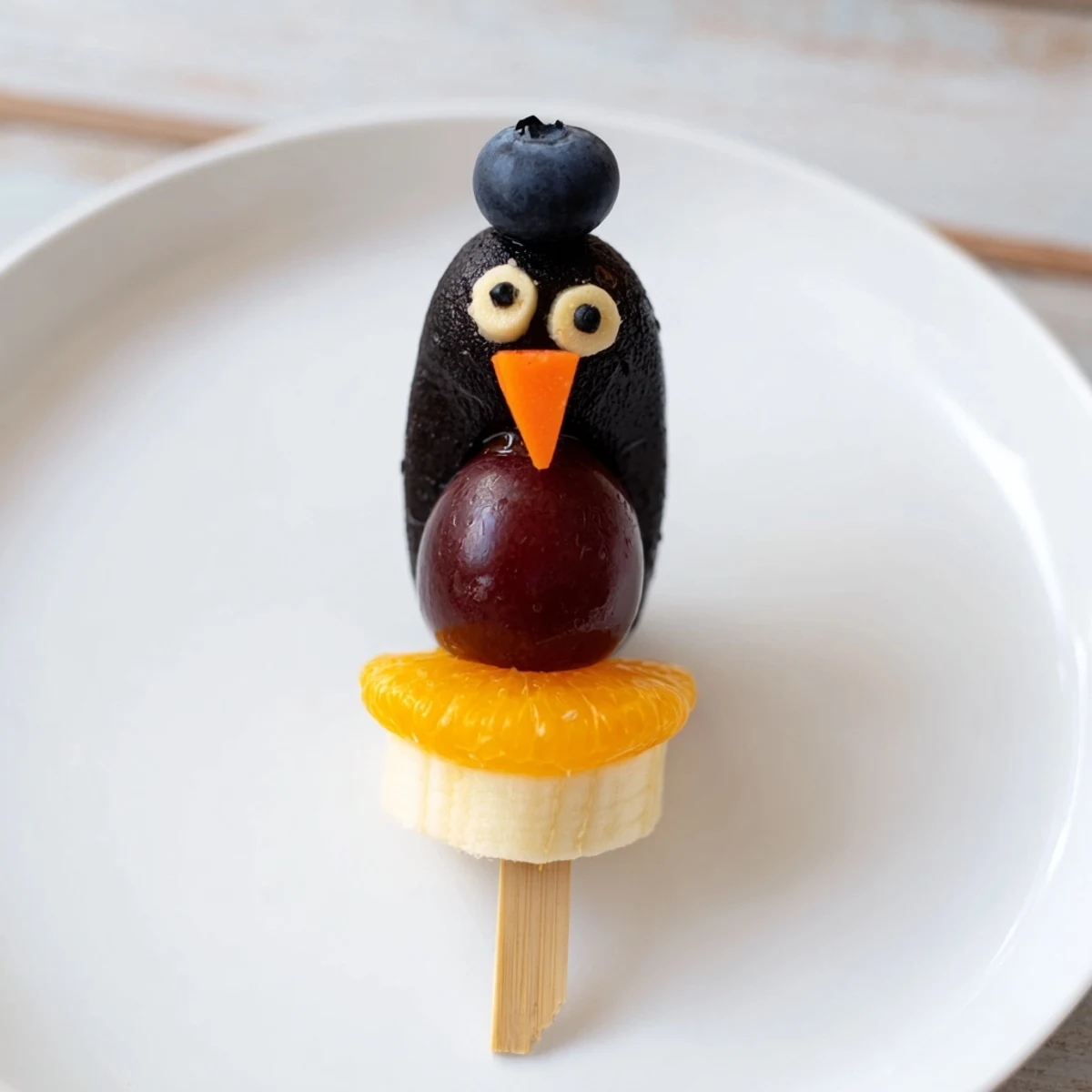 Close-up of the fun Penguin Fruit Skewer Army display, ready to enjoy this delightful, fruity snack.
