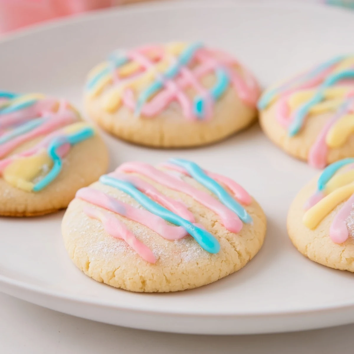 Freshly baked sugar cookies with a delightful icing drizzle, ready to brighten any dessert table.
