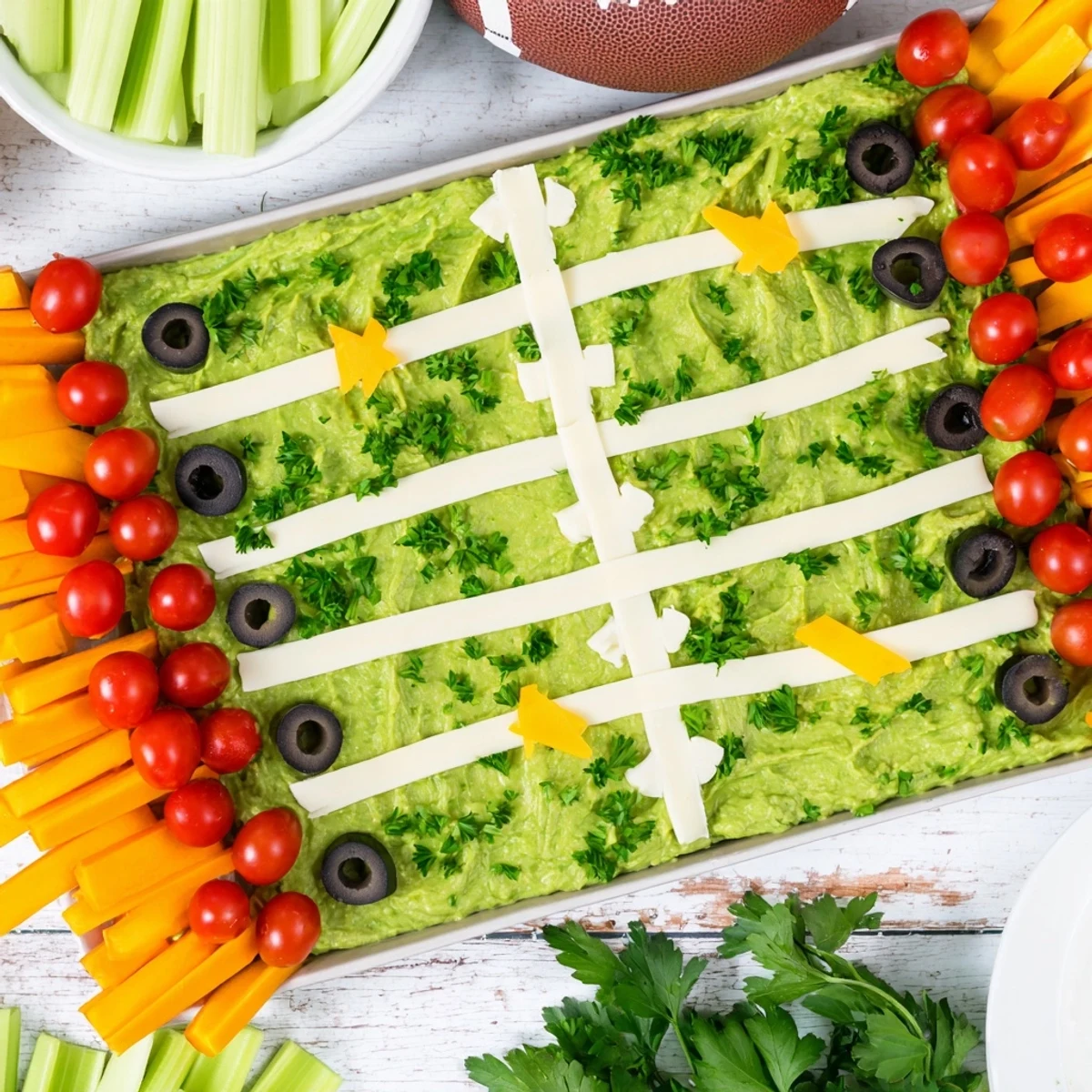 Vibrant Game Day Football Field Snack Board with guacamole, chips, and cheese yard lines.