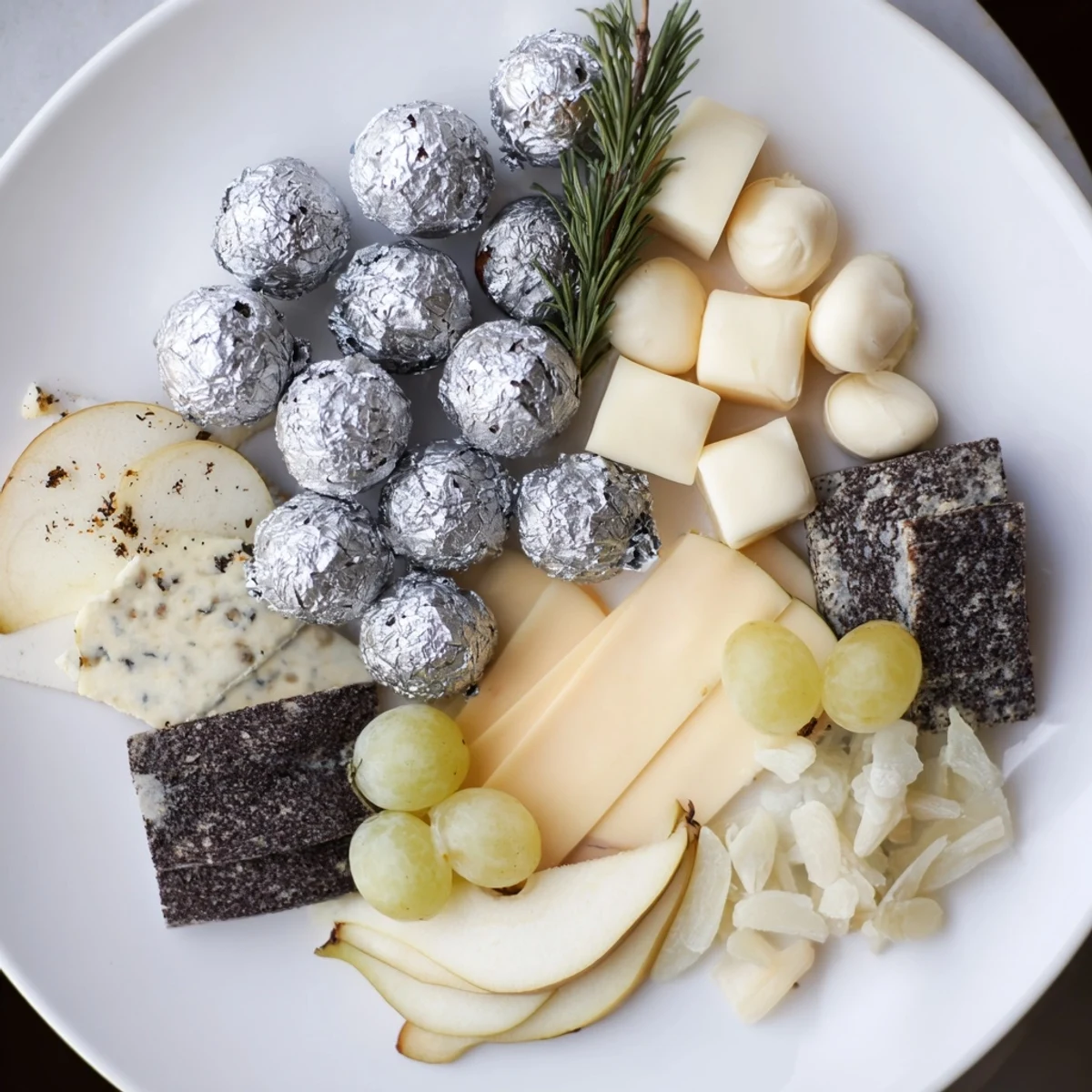 Elegant The Silver Screen cheese board, presenting creamy cheeses, silver chocolate, and crisp crackers.