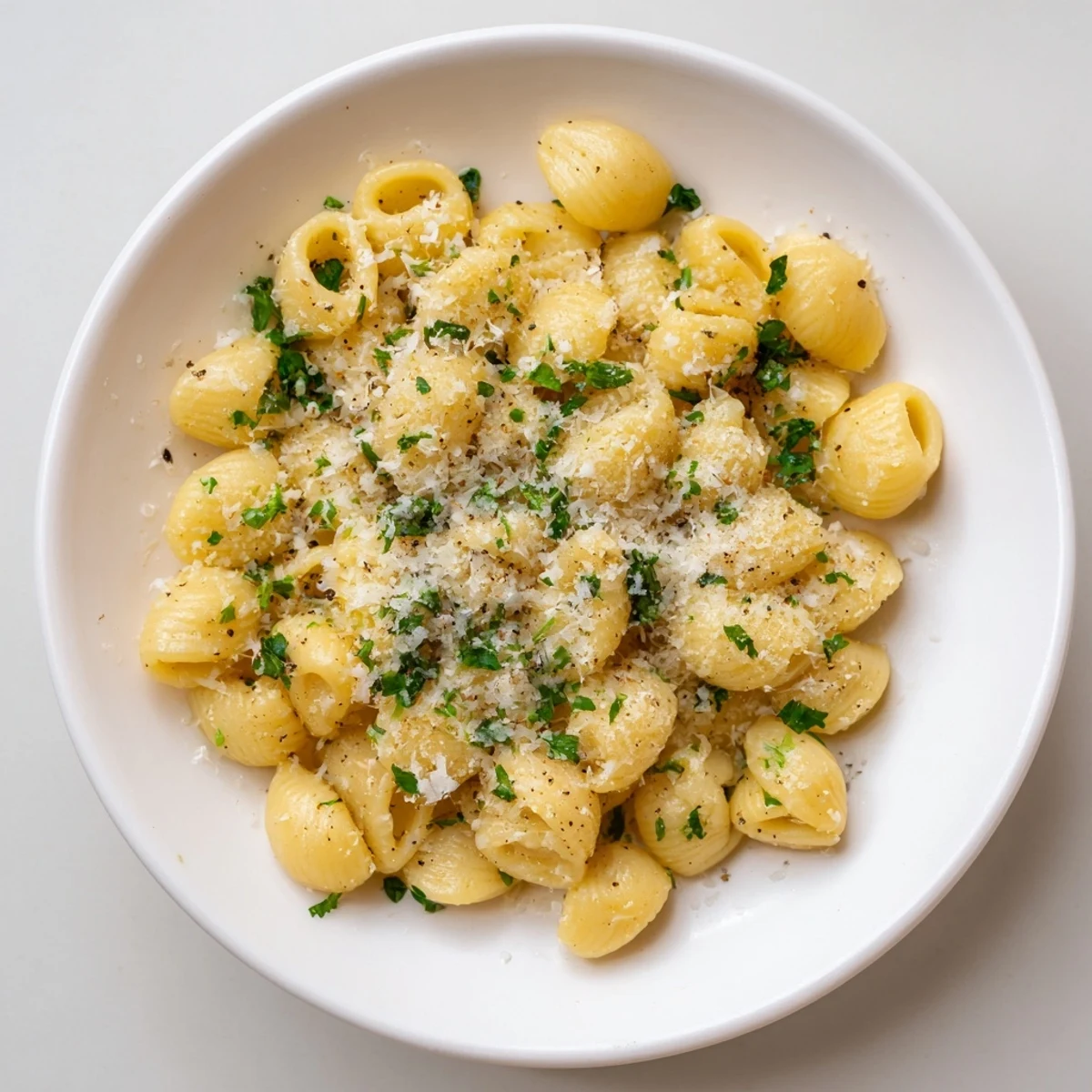 Steaming bowl of one-pot garlic butter ditalini, garnished with fresh parsley and Parmesan cheese.