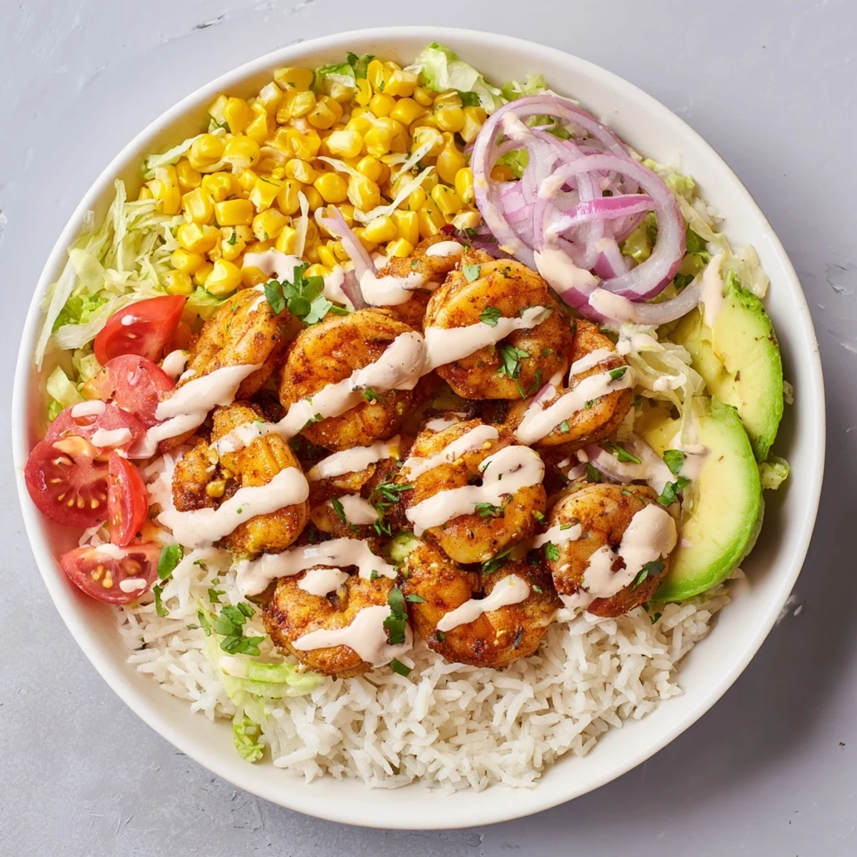 Sizzling Cajun shrimp atop fluffy rice and fresh toppings makes these satisfying taco bowls irresistible.