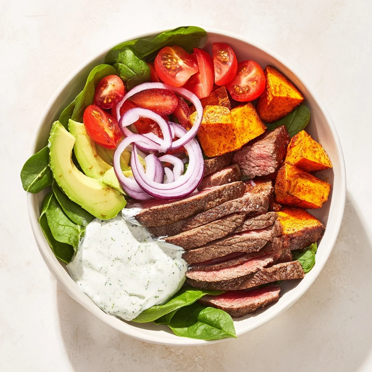Roasted sweet potatoes and seasoned beef in a delicious, gluten-free beef avocado sweet potato bowl.