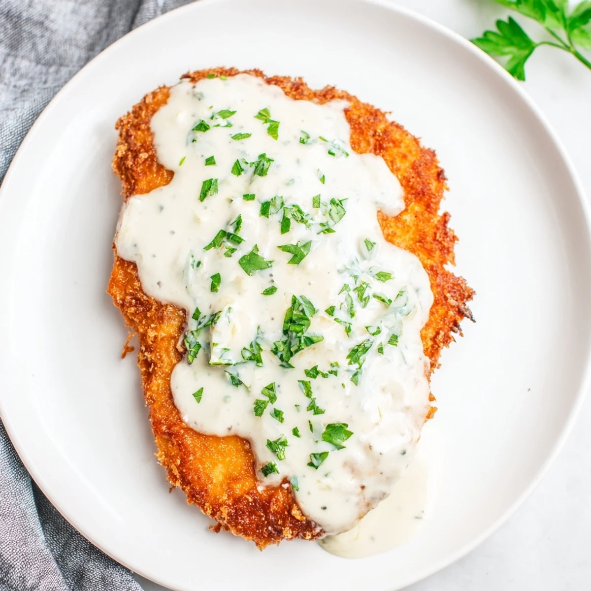 Mouthwatering image of Crispy Chicken with Garlic Cream Sauce glistening, and ready to be served.