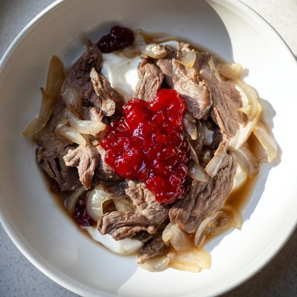 Finnish Reindeer Stew, a hearty dish with tender meat and creamy sauce, ready to serve with berries.