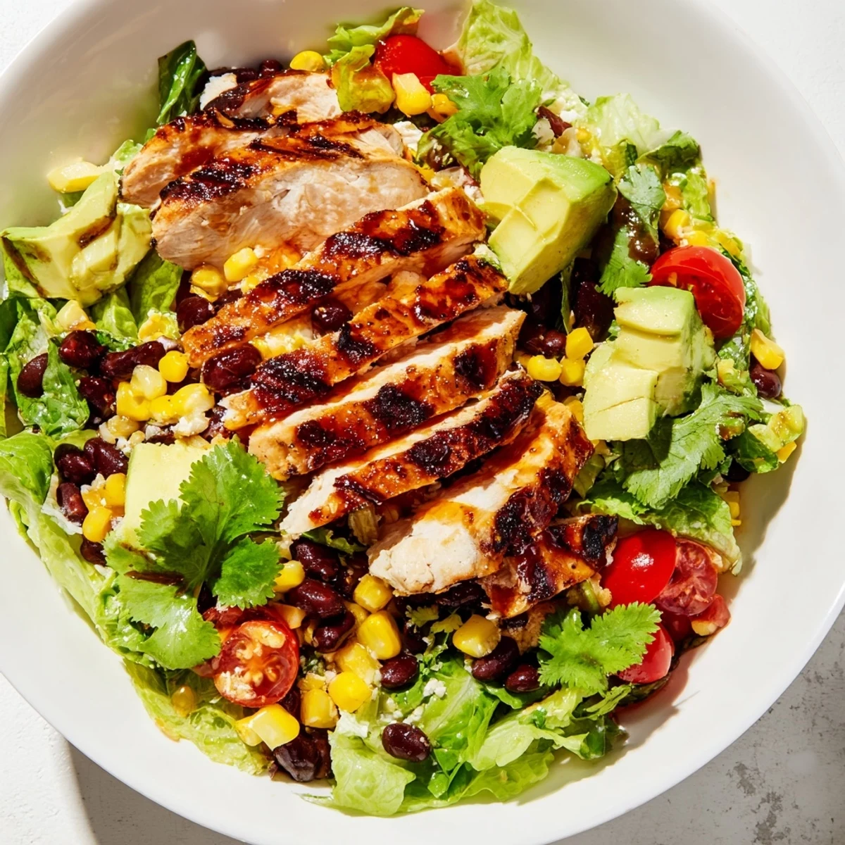 Crisp romaine lettuce topped with tender grilled chicken marinated in a honey-lime glaze for a refreshing Honey Lime Chicken Taco Salad.
