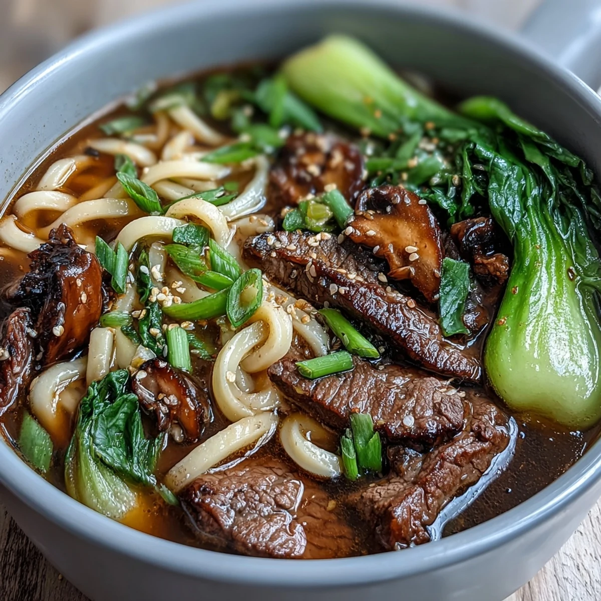 Colorful Mini Hot Pot Bowls filled with udon noodles, shrimp, and crisp bok choy, perfect for customizable meals.