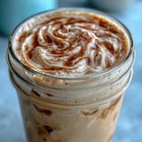 Creamy skinny vanilla bean frappuccino with almond milk, topped with light whipped cream and a sprinkle of vanilla bean seeds.