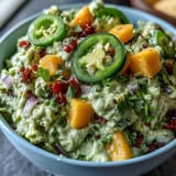 Creamy guacamole with sweet mango and spicy jalapeño, perfect for Cinco de Mayo celebrations or as a fresh appetizer.