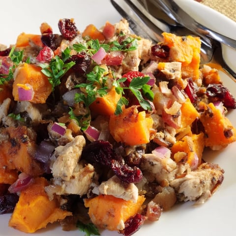 Hearty Rustic Skillet Turkey and Cranberry Hash topped with fresh parsley and vibrant veggies.  