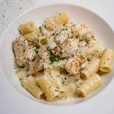 Creamy Garlic Parmesan Chicken Rigatoni with golden chicken and rich, bubbling, white sauce.
