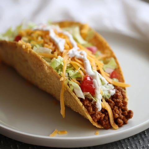 Cheesy Gordita Crunch tacos, overflowing with seasoned beef, crisp lettuce, and melty cheese, look delicious.