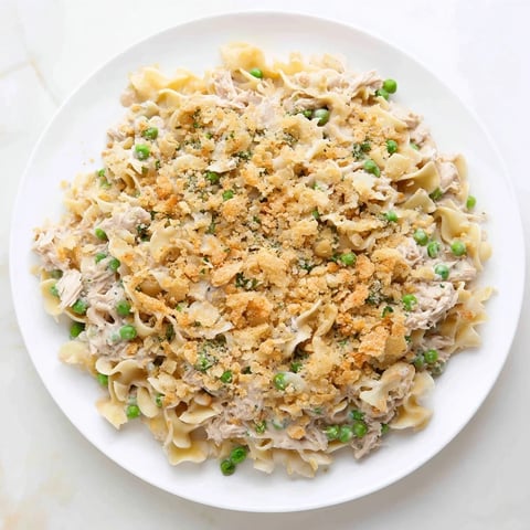 Golden-brown Creamy Tuna Noodle Casserole with a crispy Ritz cracker topping, ready to serve.