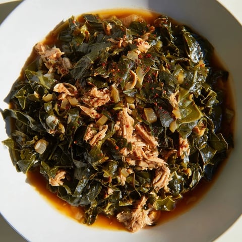 Steaming bowl of Southern Style Collard Greens with smoked turkey, full of savory aromas.