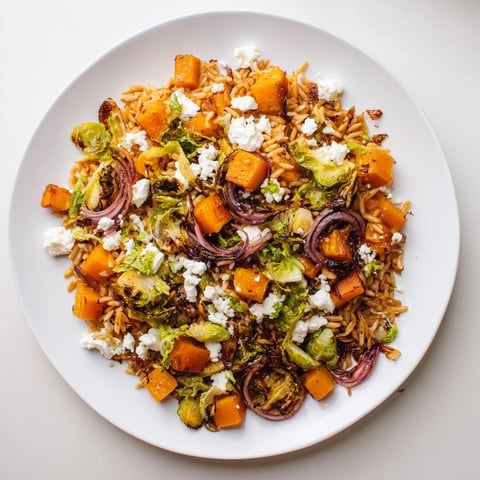 Vibrant Best Fall Harvest Orzo Salad with roasted butternut squash, brussels sprouts, and creamy goat cheese.