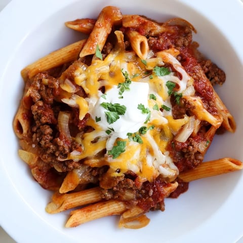 Easy Beef Enchilada Pasta, a one-pot meal of ground beef and melty cheddar cheese.