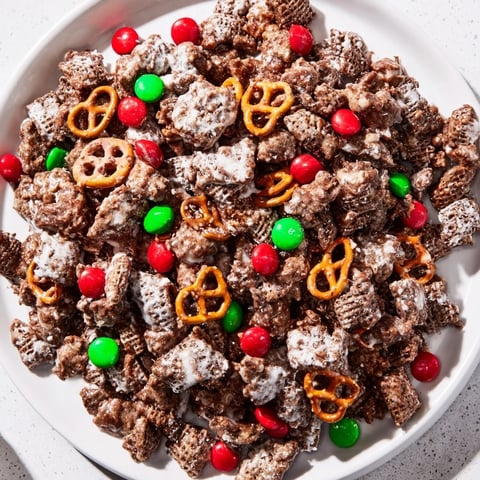 Sweet, chocolate-covered Simplified Reindeer Chow mix with colorful candies, perfect for festive snacking.