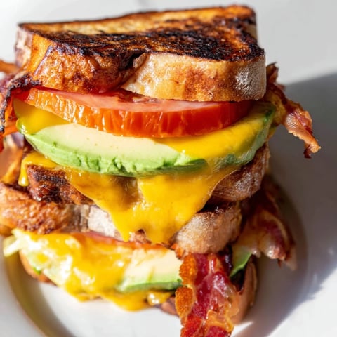Golden, buttery sourdough grilled cheese stuffed with crispy bacon, fresh lettuce, tomato, creamy avocado, and melted cheddar.
