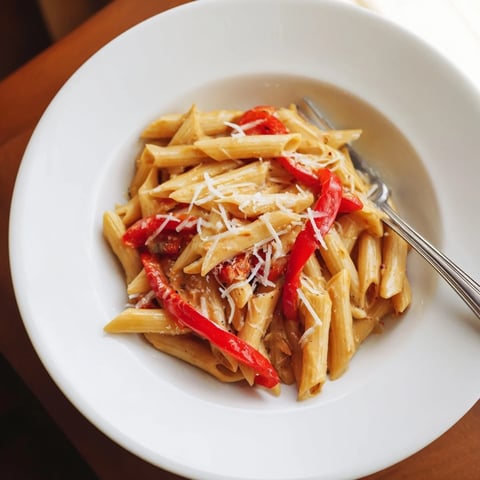 Creamy Cajun pasta with al dente penne coated in a rich, spicy cream sauce and topped with sweet roasted red bell peppers and fresh parsley.  