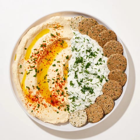 Easy Dips: A vibrant spread of hummus and creamy yogurt dip, ready for dipping with crackers.