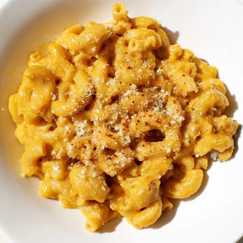 A comforting bowl of creamy Pumpkin Mac & Cheese, with swirls of orange pumpkin and sharp cheddar.