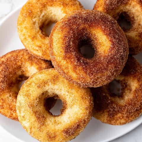 Fluffy biscuit dough donuts, air-fried to perfection and brushed with melted butter, ready to enjoy with coffee.