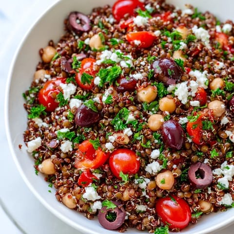 This hearty Greek Power Salad features chickpeas, cherry tomatoes, and feta cheese on a bright serving platter.  