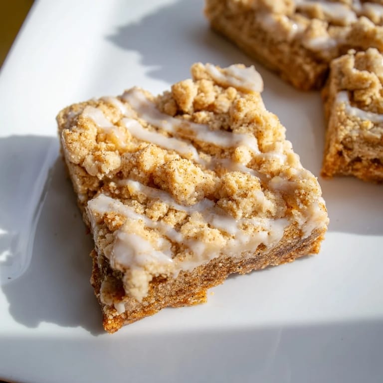 These festive Lemon-Glazed Gingerbread Crumble Bars are moist, delicious, and ideal with a steaming cup of tea.