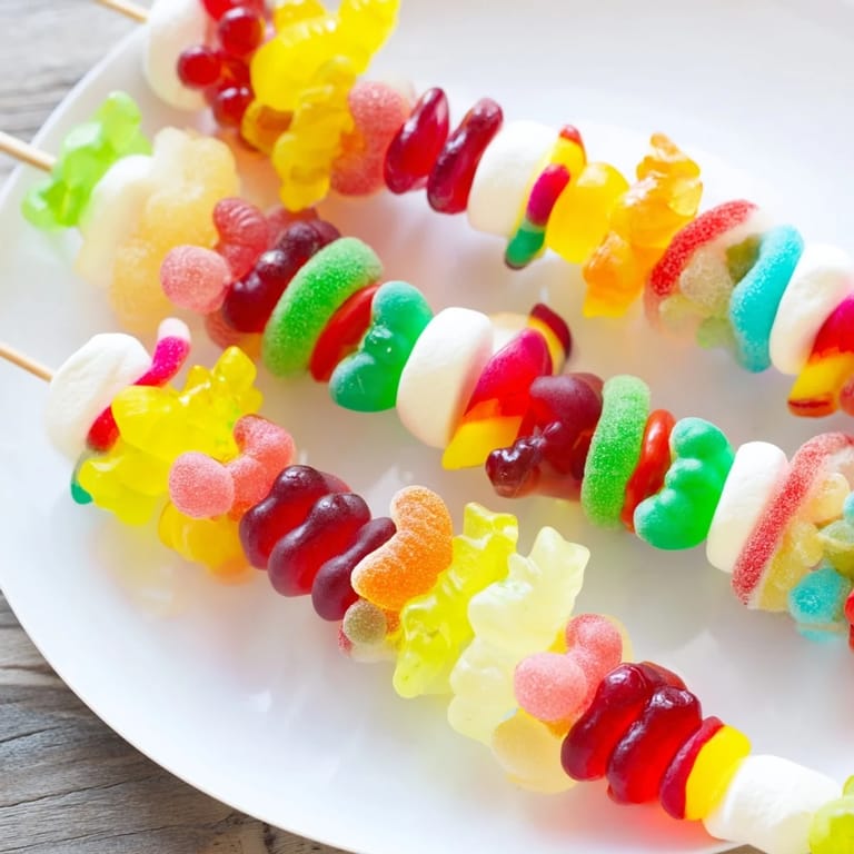 Delicious Gummy Candy Kabobs, threaded with colorful sweets, perfect for a fun dessert.