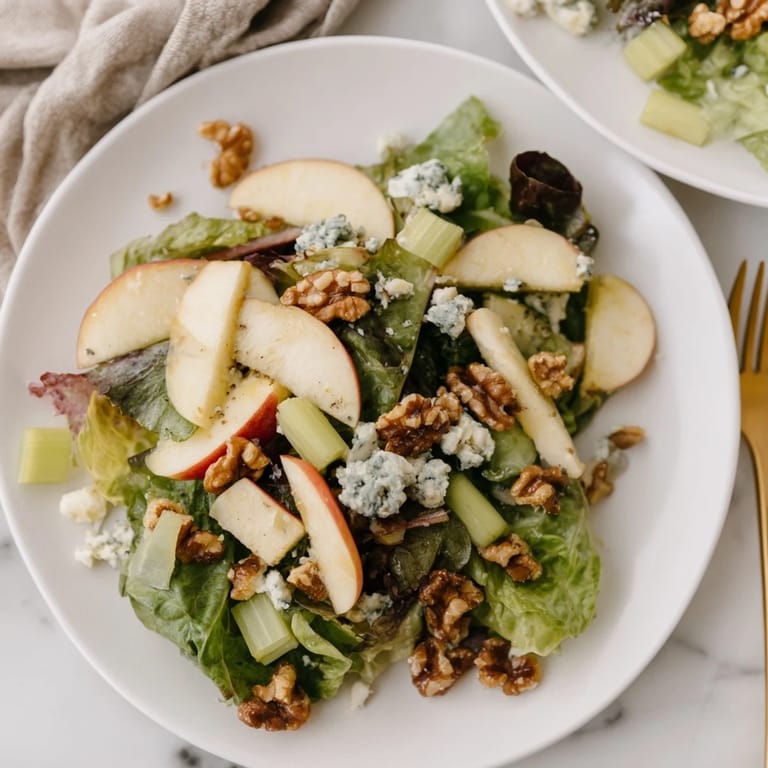 Close-up of apple and walnut salad with celery and vinaigrette, a refreshing side.
