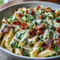 Creamy Leek, Pea, and Ham Pasta in a skillet with a rich, savory sauce and tender pasta.