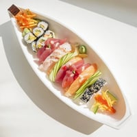 Vibrant Sail Away Boat-Shaped Sushi Platter showcasing fresh tuna, salmon, shrimp, and colorful sushi rolls waiting to be enjoyed.