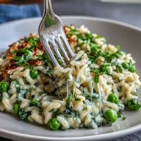 Creamy Spring Pea Risotto with fresh mint and Parmesan, a vibrant vegetarian dish perfect for spring dinners.  